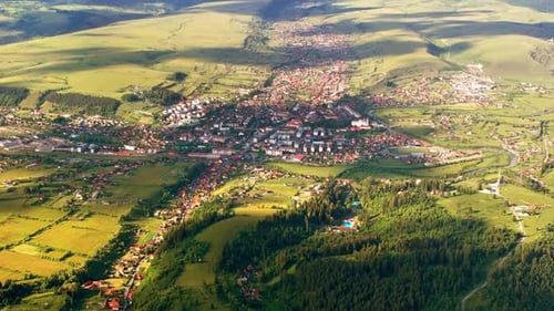 Aerial drone view of Toplita in the Carpathians in Romania. Village, fields and low hills