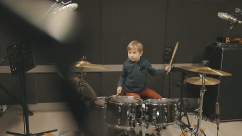 Young Talented Kid Playing Drums in a Professional Recording Studio