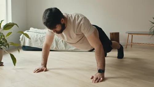 Strong Bearded Man Doing Push Ups Exercise at Home