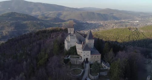 Orbiting Drone Shot of a Castle with Mountains and a Valley in the Background, 4k UHD