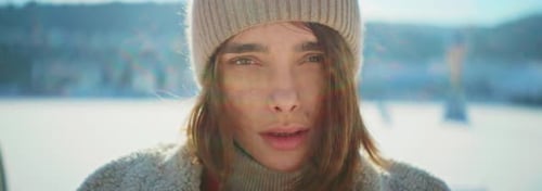 Footage of Attractive Young Woman Trying to Warm Up on Blurred Background of Mountain Caucasian Girl