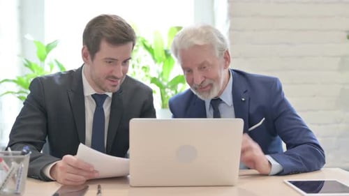 Two Businessmen Working Together at the Office