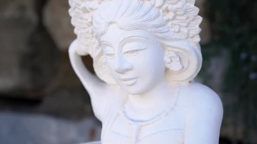 White Statue of Indian Deity in Garden