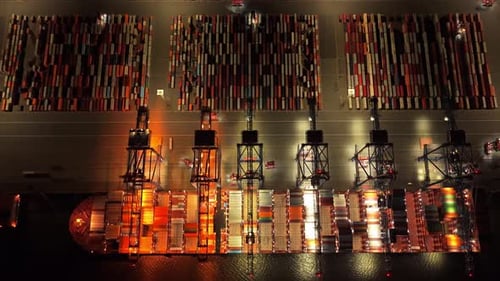 Night-lit freight terminal with cranes and global trade