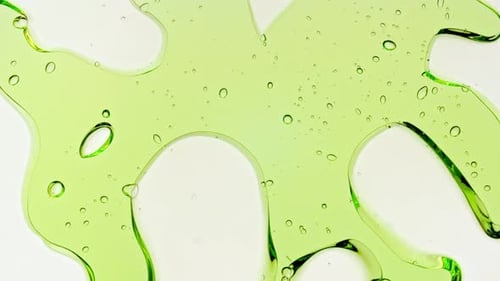 Transparent Green Cosmetic Gel Fluid With Molecule Bubbles and Oil on White Background