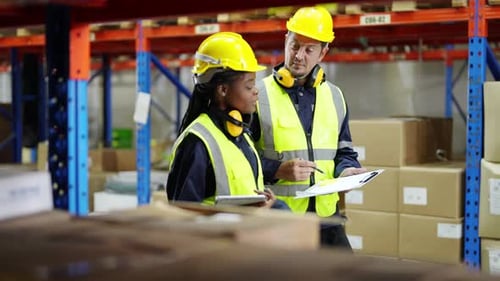 Warehouse Industrial and Logistics Companies. Dispatcher in uniform making inventory in storehouse.