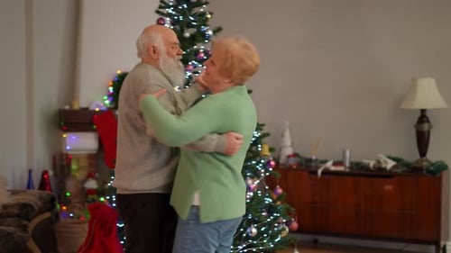 Senior Couple Dancing at Christmas by Christmas Tree