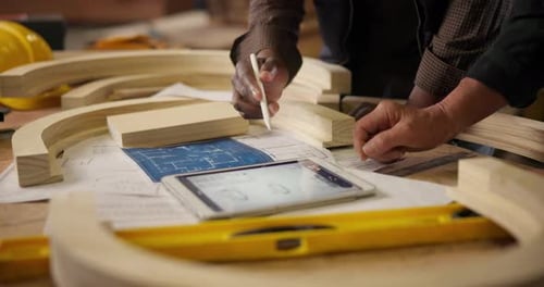 Carpenter, hands and tablet with digital plans for construction, furniture or project