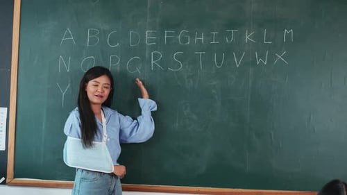 A Woman is Teaching a Class in a School