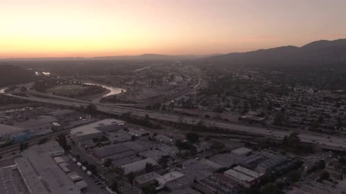 A high altitude horizontal pan during sunset at Glendale, California, USA, facing the sun. A busy in