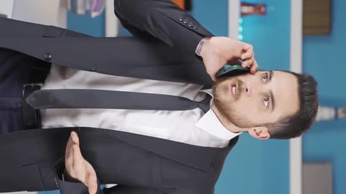 Young Adult Man Talking on Phone Wearing a Suit
