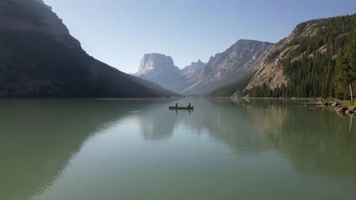 People Kayaking On Green River Lakes With Mountainscape Background In Wyoming. Aerial Wide Shot