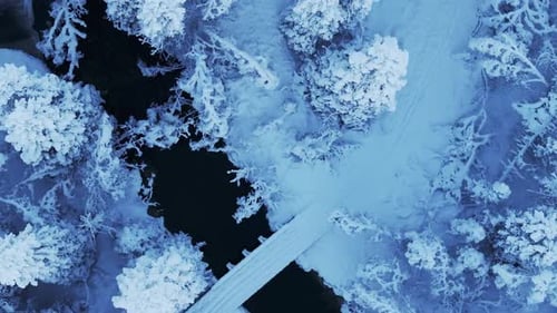 Above View Of Frigid Weather Over Frozen River And Forest During Winter In Norway. Aerial Shot