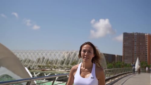 Woman Jogging on a Bridge on Sunny Day