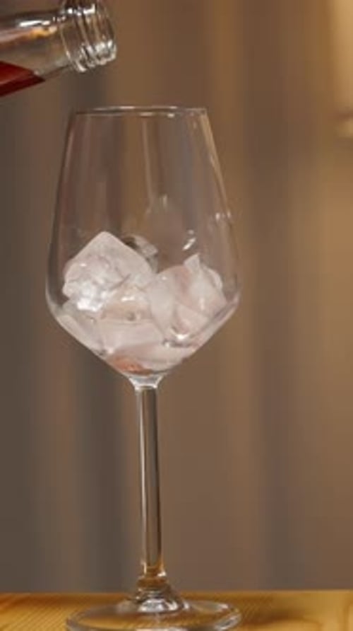 Pouring Drink into Ice Filled Glass