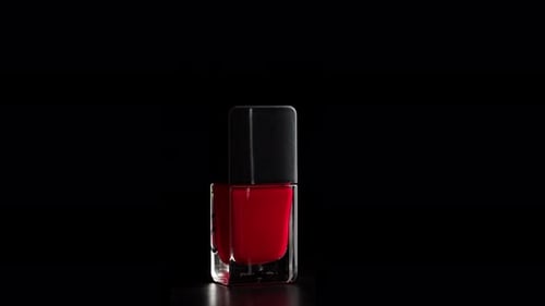 Red Nail Polish Bottle on Black Background
