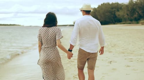 Young couple enjoying fresh air on sandy beach in beautiful Australia