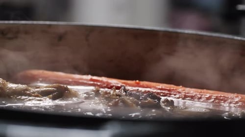 Carrots and Meat Simmering in a Pan