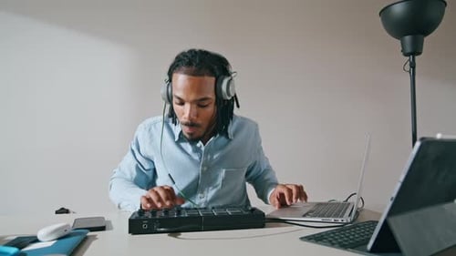 Young Adult Working on Music with Technology