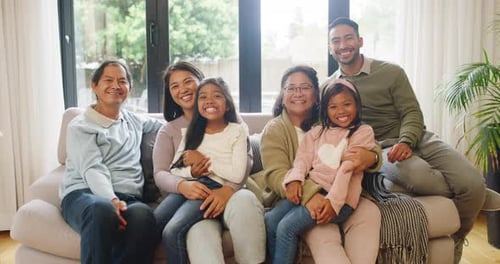 Multi-generational Family Smiling Together on Couch