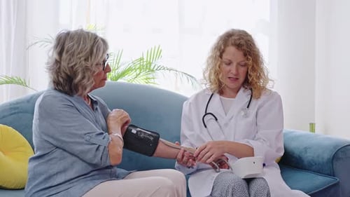 Senior Patient Receiving Blood Pressure Check at Home