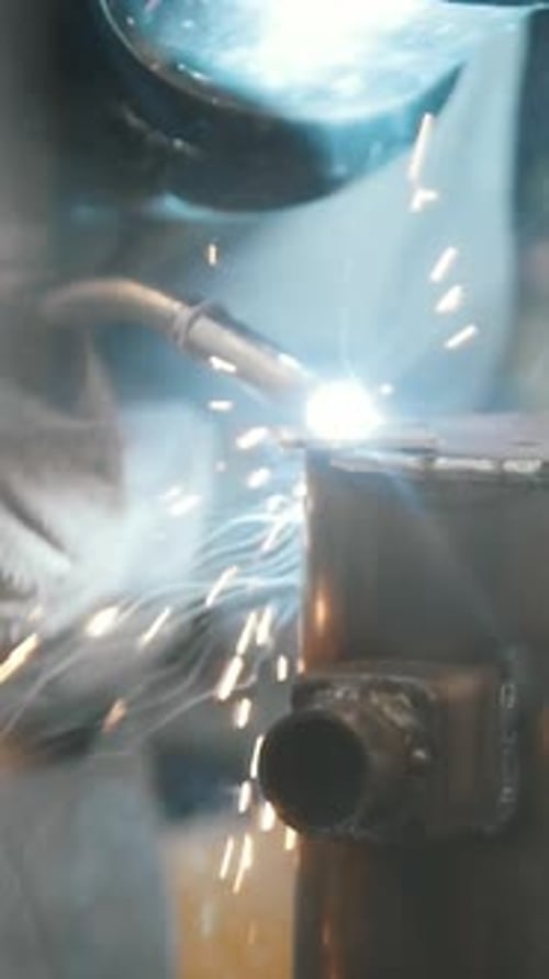 The Welder Welds Metal Parts at the Plant Industrial Welding