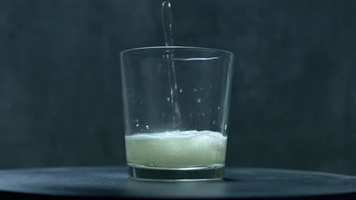 A Close Up Static View of Soda being poured into a glass in Slow Motion. Shot in 60fps on a Sony FX3