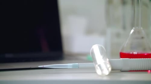 Laboratory Equipment on Table, Beaker with Red Liquid