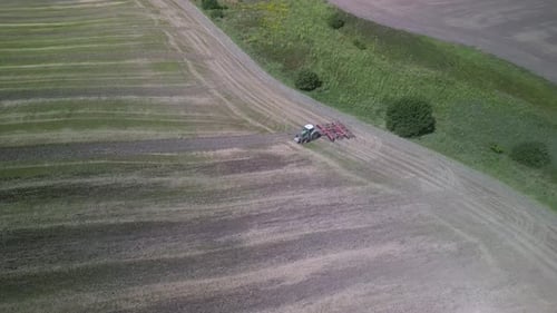 Tractor working on the field doing tillage with cultivator