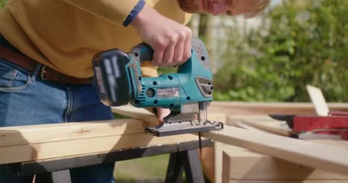 Close up of sawing wood with jigsaw