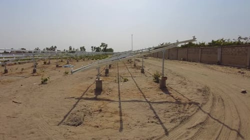 Handheld panorama of solar panel string frames during a renewable energy solar farm project construc