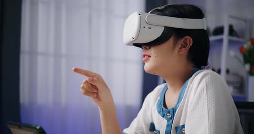 Woman Interacting with Virtual Reality Headset Indoors