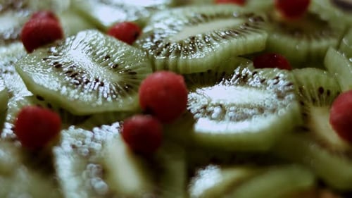 Close-Up of Sliced Kiwi Fruit and Red Berries