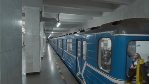 Blue Subway Transit Train Leaving Empty Underground Station