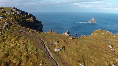 Aerial view of Måtinden with hikers walking on a trail surrounded by breathtaking nature