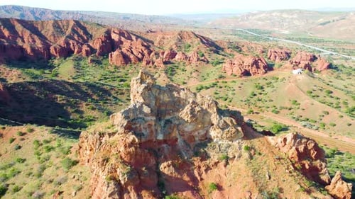 Flying over Mountain Peak and Red Rocks