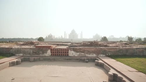 Ruins of Ancient Temples on the Background of the Taj Mahal