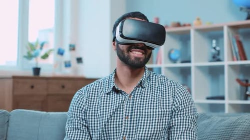 Man wearing VR headset smiling in bright home