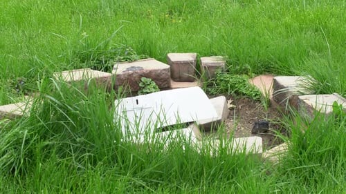 Thrown office printer copier breaking into pieces in circle of bricks conceptual rage mood