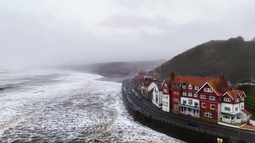 Stormy winter scene. Rough seas of the English coast with mist and fog. Aerial footage of the sleepy