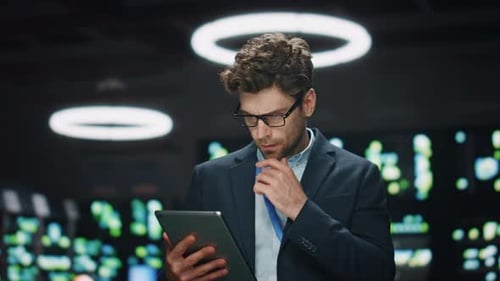 Man Working with Tablet in Darkened Office Setting