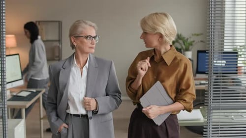 Successful Female Entrepreneurs Discussing Business in Open Space Office