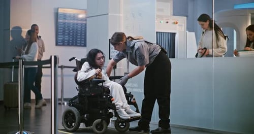 Airport Security Inspecting Traveler in Wheelchair