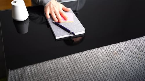 Organizing a Notebook with Stationary on a Desk