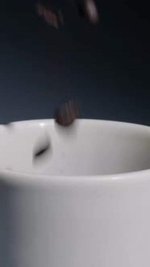 Extreme Slow Motion Close-up of Coffee Beans Falling into Cup