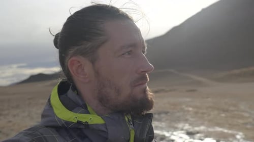 Man with Beard Contemplates Wilderness Landscape