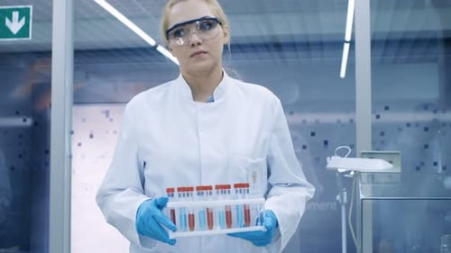 Scientist Holding Test Tubes in a Lab