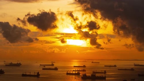 Sunrise time lapse of hundreds of cargo ships off the coast of Singapore.