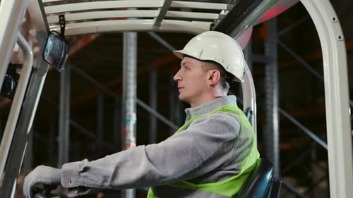 Logistic Guy Caucasian Worker Operating Forklift at Logistic Center Inside People at Work