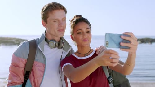 Interracial, selfie and couple with smartphone, beach and bonding together on vacation